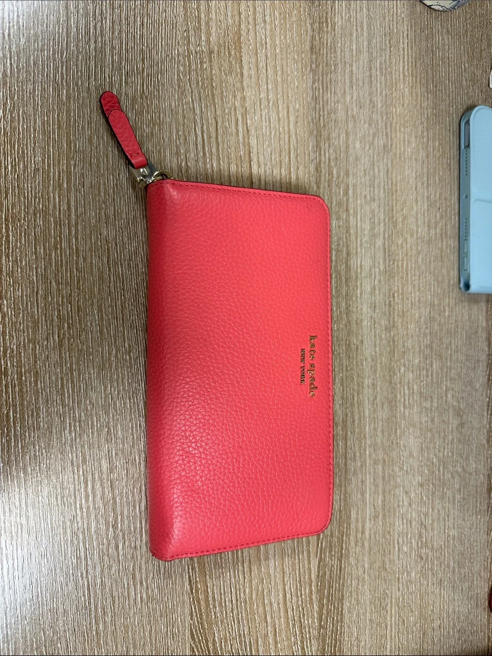 kate spade coral pink zip-around pebble leather wallet with wrist strap